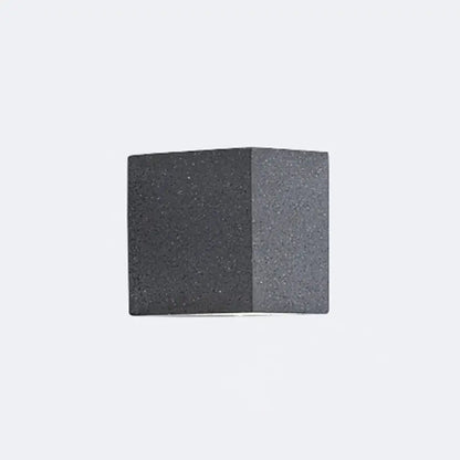 Minimalist dark gray speckled concrete cube wall sconce with led light for corridor lighting