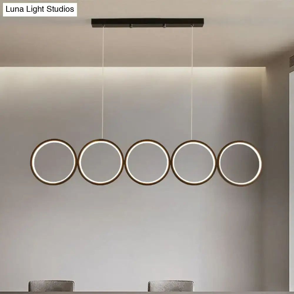 Modern black minimalist metallic led suspension lamp with five illuminated circular rings providing warm white light