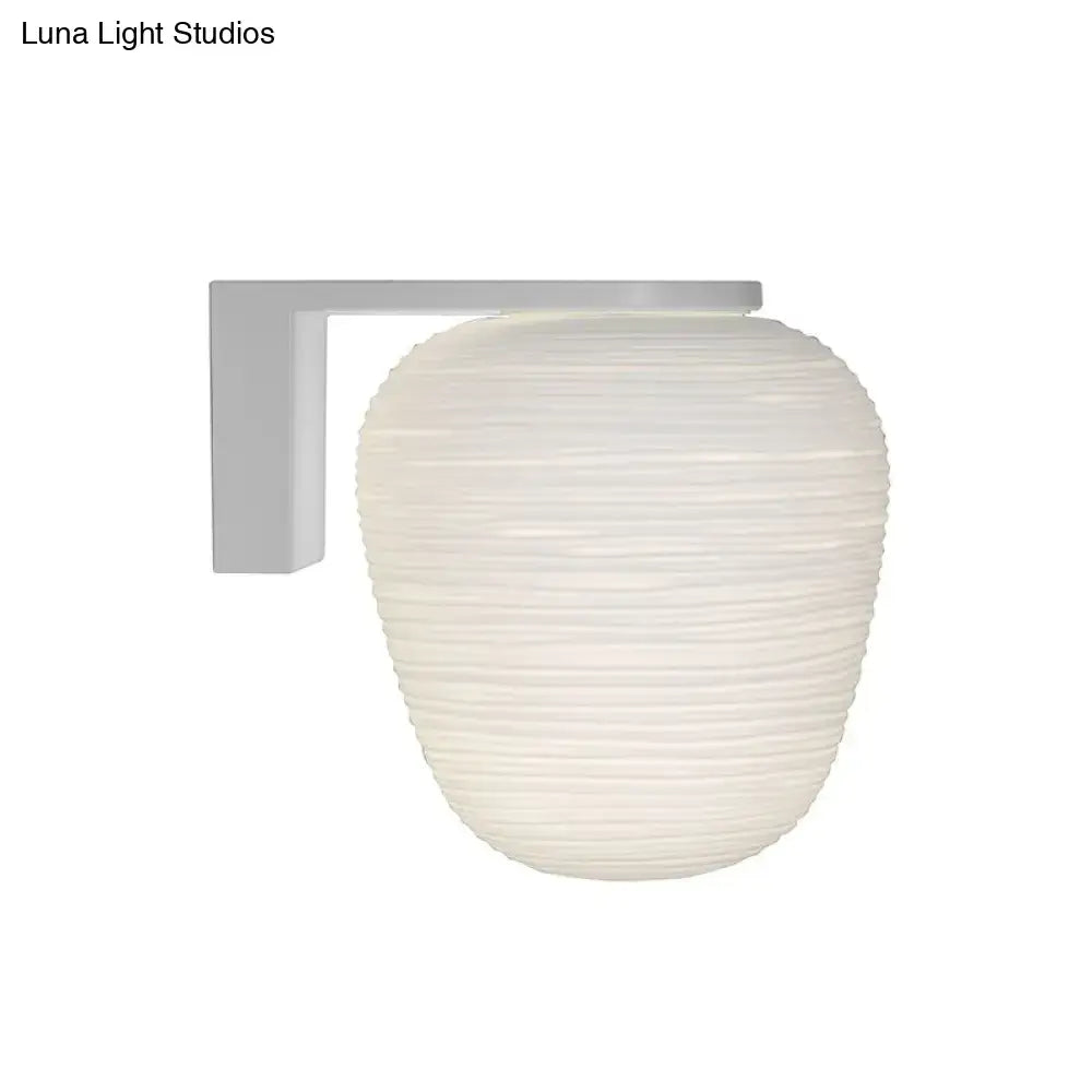 Off-white ribbed glass lantern-style wall mounted lighting with milky ribbed glass and white metal bracket for bedroom use