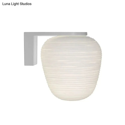 Off-white ribbed glass lantern-style wall mounted lighting with milky ribbed glass and white metal bracket for bedroom use