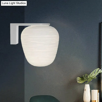 White ribbed paper lantern wall sconce with milky ribbed glass and minimalist rectangular wall mounted lighting bracket