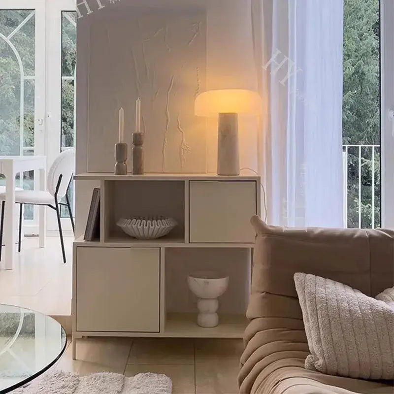 Beige modular storage unit with open and closed compartments displaying decorbites cave stone table lamp with frosted glass