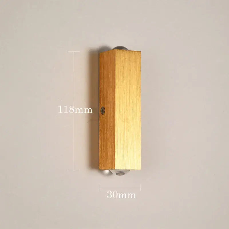Minimalist natural wood angled wall lamp with decorbites brushed gold finish and subtle wood grain for bedroom decor