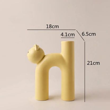 Minimalist pastel yellow ceramic decorbites cathead tube vase with smooth rounded features for living room decor