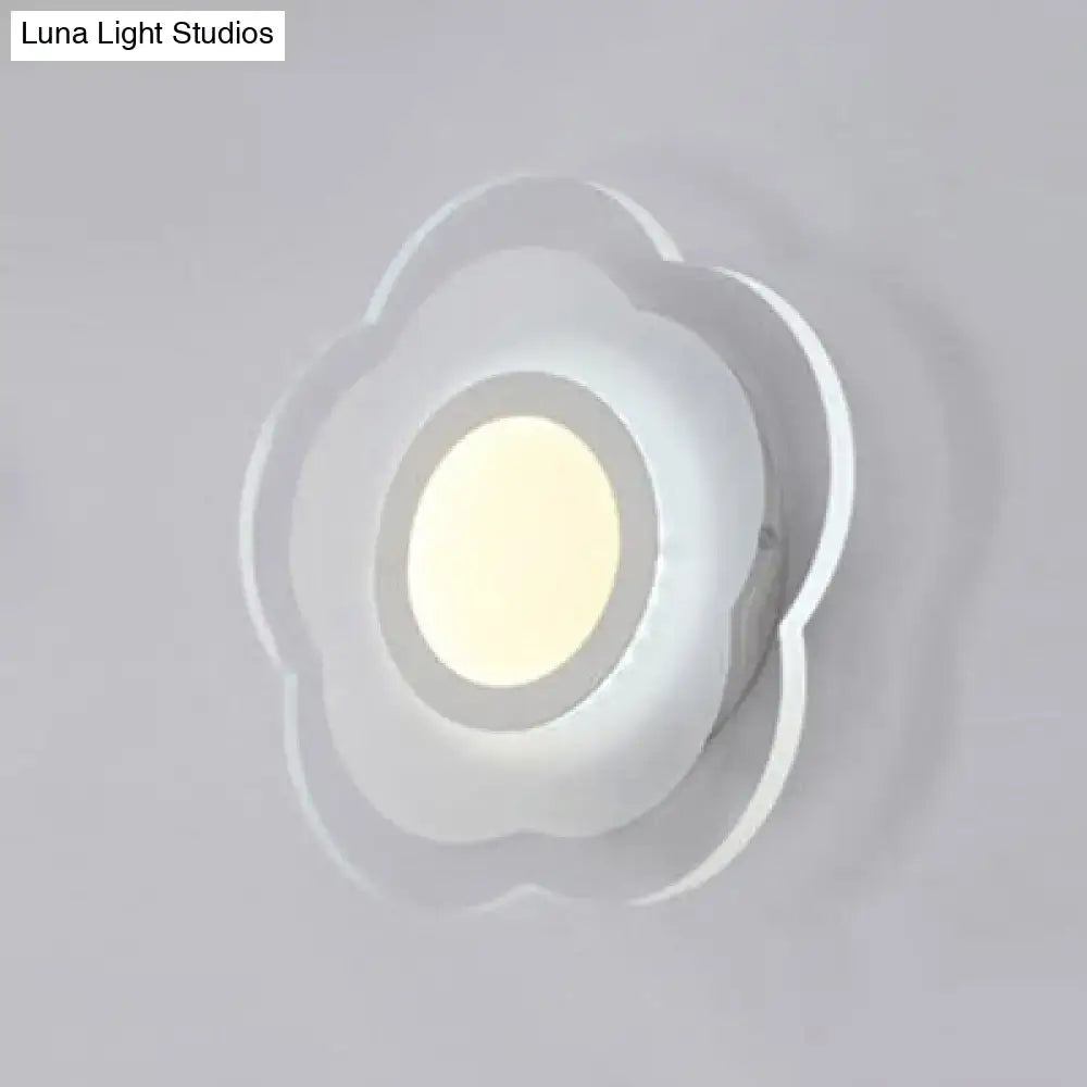 A modern off white cloud-shaped wall lamp with a soft glowing center featuring triangle round square design elements
