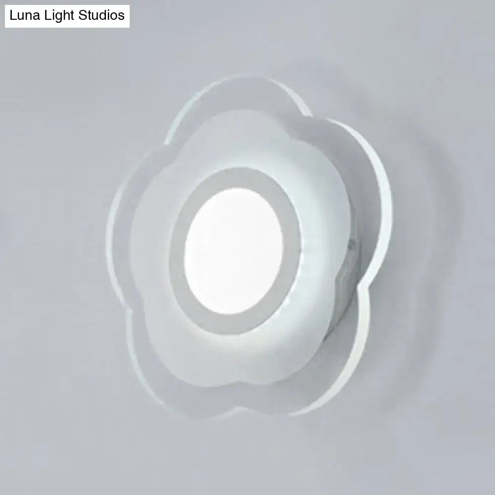 A minimalist off white wall lamp with a triangle round square design and a frosted glass cloud-shaped diffuser