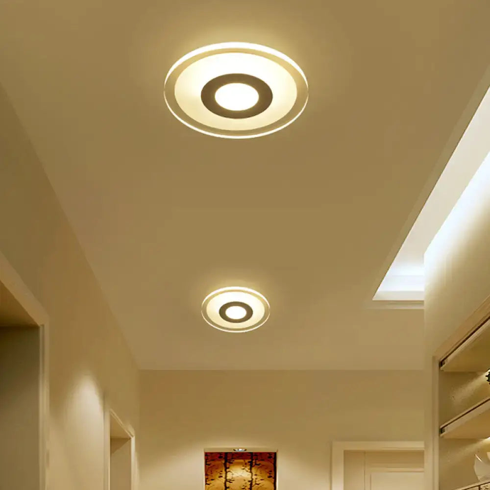 Modern wall lamp with minimalist off white square design featuring triangle round shape and warm glowing concentric rings