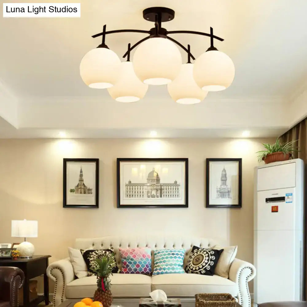 Black metal DecorBites™ minimalist chandelier with five frosted opal glass globes for living room ceiling light