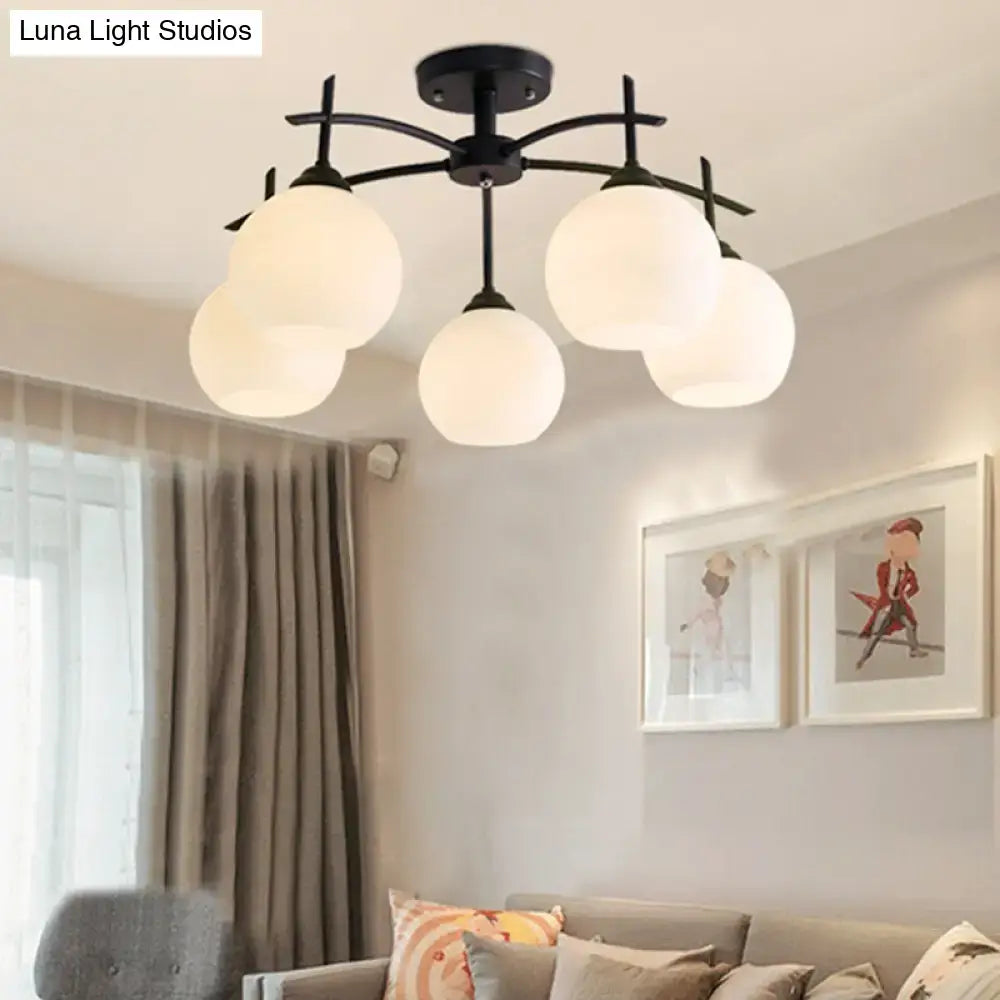 Black metal chandelier ceiling light with five frosted opal glass globe shades for living room use
