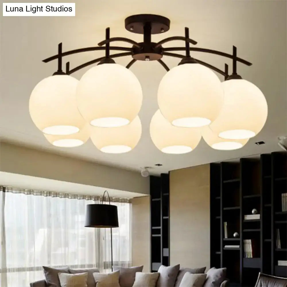 Modern black metal chandelier with six frosted opal glass globe shades for living room ceiling light decor