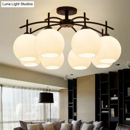 Modern black metal chandelier with six frosted opal glass globe shades for living room ceiling light decor