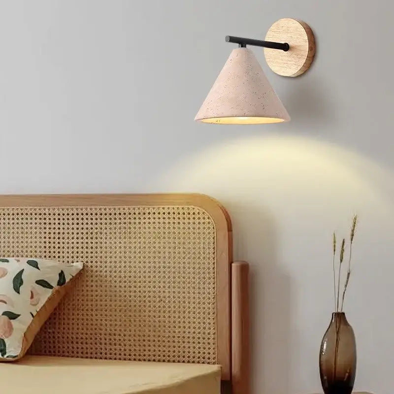 A soft pink speckled concrete cone wall light with black metal arm and round wooden backplate for decorbites iron yellow travertine wall lights