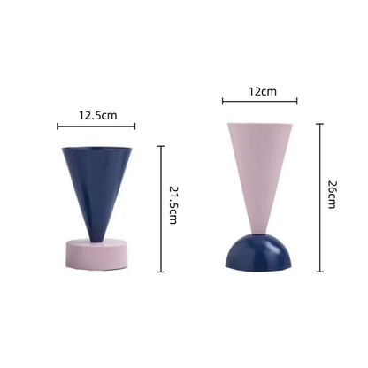 Two minimalist cone-shaped geometric triangle vases in navy blue and blush pink for decorbites geometric triangle decor