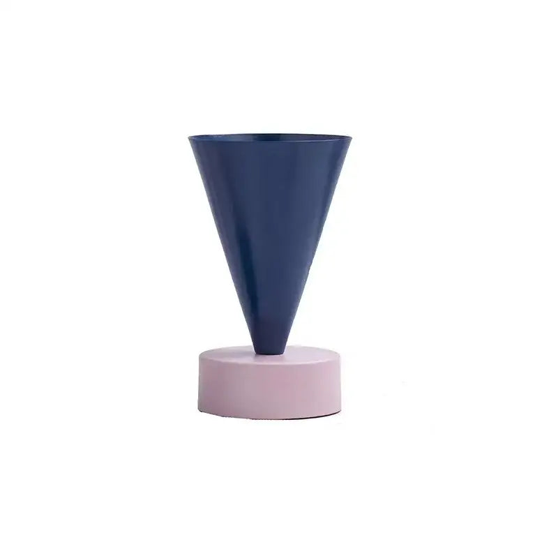 A sleek navy blue matte conical geometric triangle vase on a soft pink base for decorbites geometric triangle decor