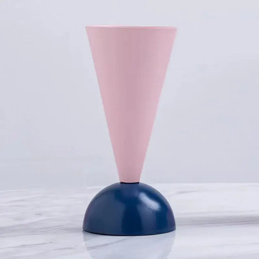 Minimalist geometric triangle vase with a matte pink cone and glossy navy blue base for decorbites living room decor