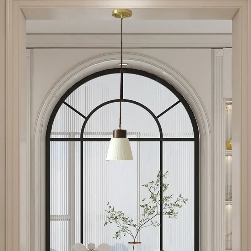 Minimalist pendant light fixture with white ribbed glass shade and dark brown metal cord ideal for kitchen lighting