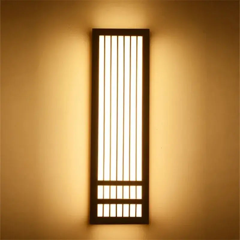 Minimalist rectangular led wood wall lamp with dark wood frame and vertical slats emitting warm ambient light for decorbites wall lamp