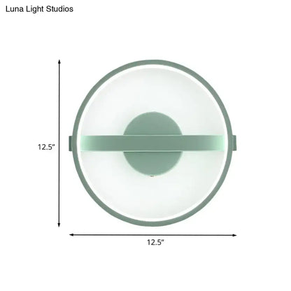 Minimalist sage green wall lamp with matte frame and translucent glass providing white warm light for bedroom