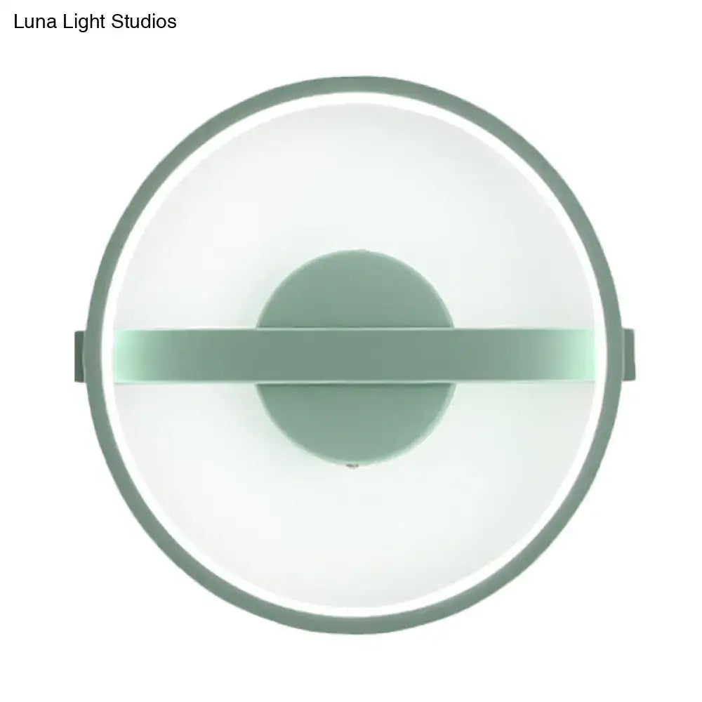 Minimalist sage green led wall lamp with circular matte frame and white warm light diffuser for bedroom use