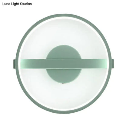 Minimalist sage green led wall lamp with circular matte frame and white warm light diffuser for bedroom use