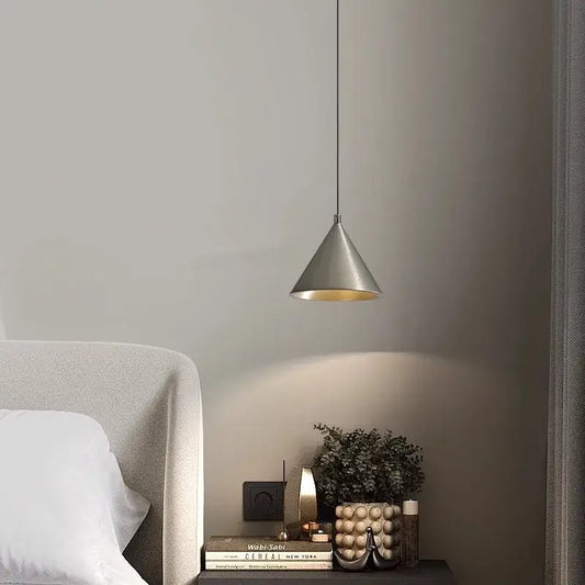 Minimalist silver and gold conical pendant light with matte exterior and warm interior for kitchen hanging lamp lighting