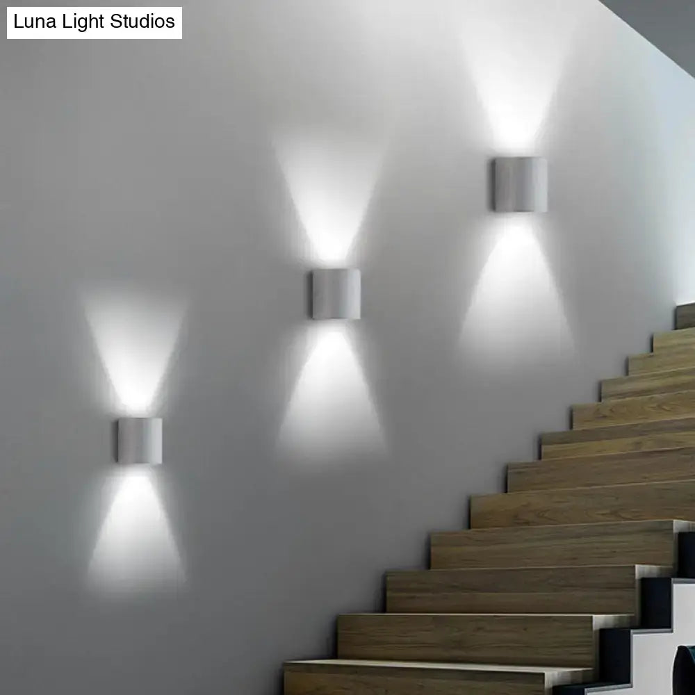 Minimalist speckled concrete led wall light with sleek white metal cylinders casting focused beams for living room