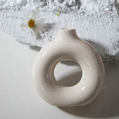 Cream-colored ceramic donut candle holder with subtle speckles minimalist speckled off-white decorbites ceramic donut