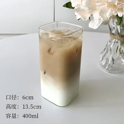 Clear rectangular glass juice cup filled with iced coffee and milk minimalist square glass juice drinkware