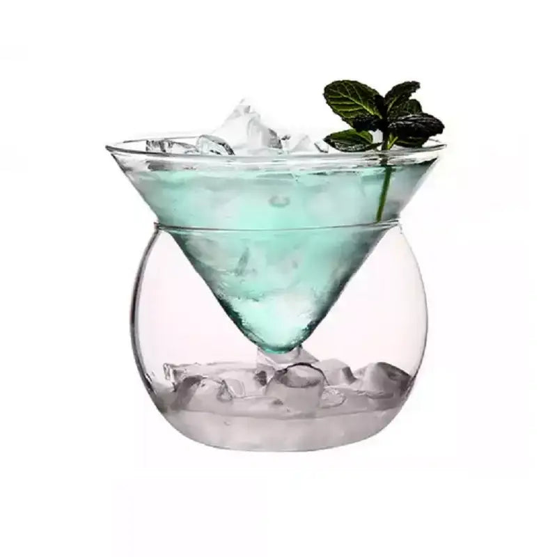 Minimalist clear glass 150ml stemless martini chiller filled with ice and a light blue drink garnished with fresh mint