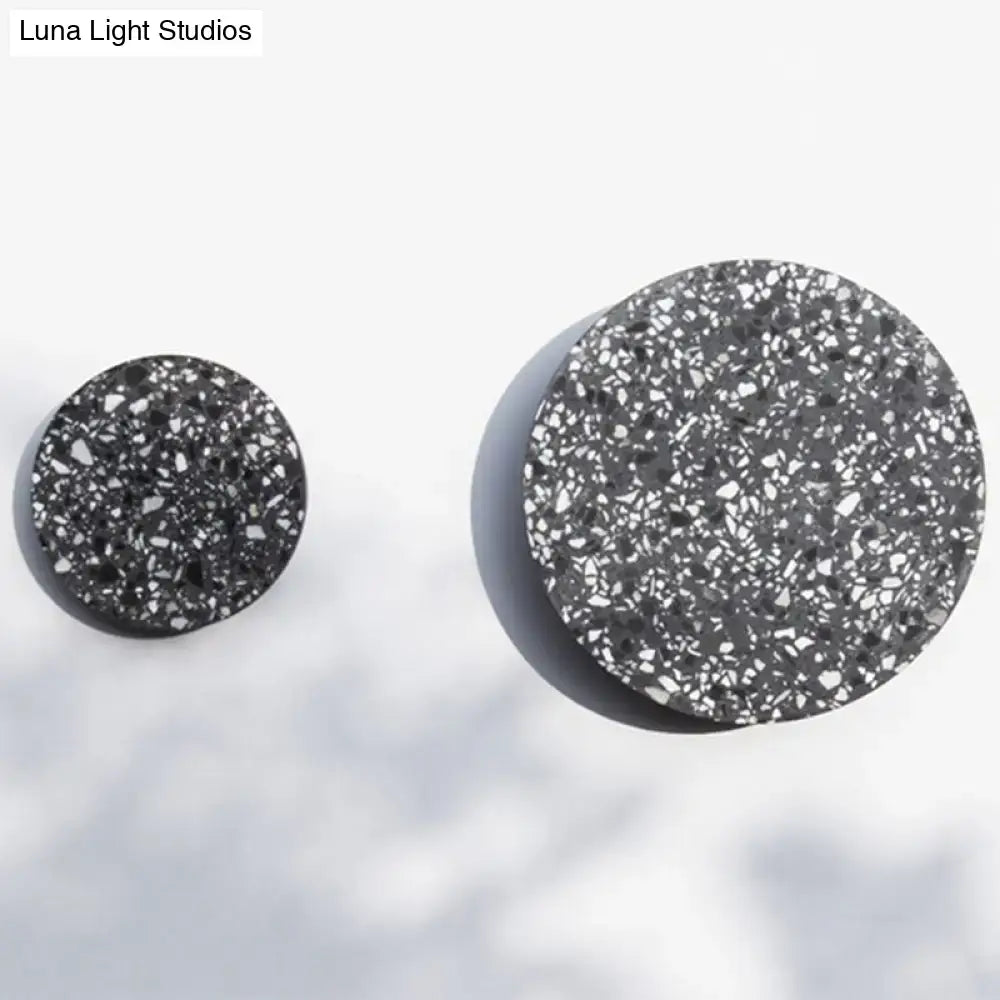 Black terrazzo circular wall-mounted knobs with a speckled textured surface for minimalist terrazzo round led wall sconce bedroom light