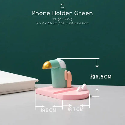 Minimalist turquoise and gold decorbites bird figurine phone holder shaped like a toucan for desktop use
