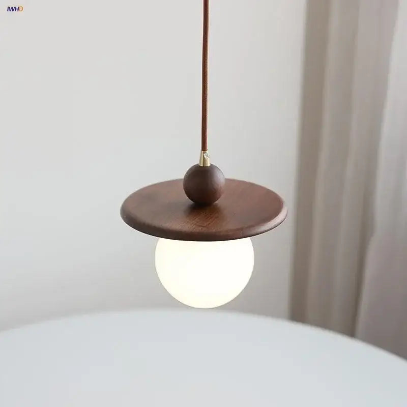 Minimalist walnut and brass glass led pendant lamp with dark brown wood disc and frosted globe for dining room lighting