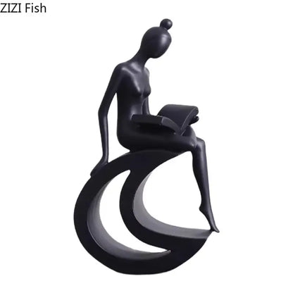 Black glossy resin abstract figures sculpture of a stylized woman seated on a crescent base reading a book for living room decor