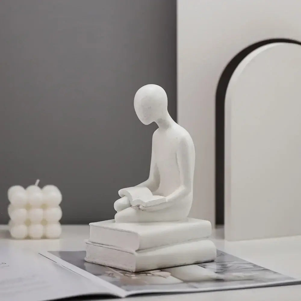 Minimalist white ceramic abstract people resin statue of a seated figure reading a book for living room decorbites decorbites abstract people