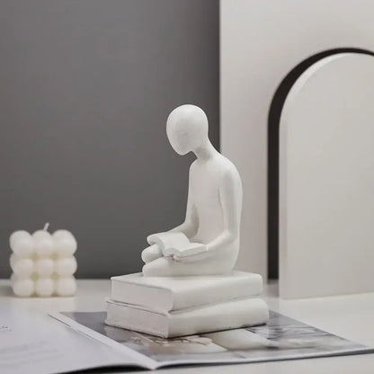 Minimalist white ceramic abstract people resin statue of a seated figure reading a book for living room decorbites decorbites abstract people