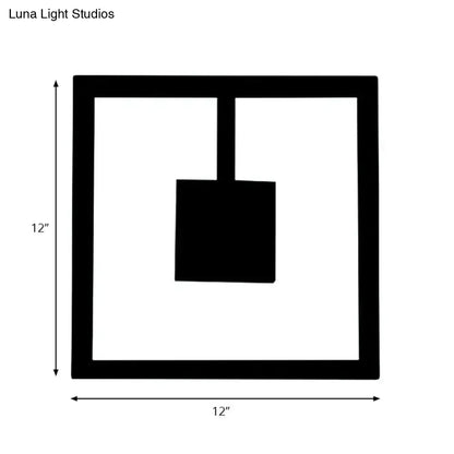 Black square minimalist wall art with hanging shovel silhouette paired with white acrylic direct wired electric light fixture
