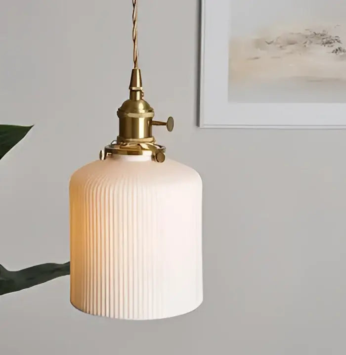 Minimalist white ribbed glass pendant light with brass fixture for bedroom featuring a stylish glass pendant light