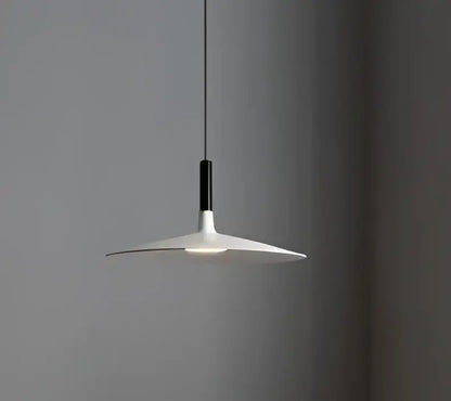Minimalist white and black glass pendant light with a sleek disc-shaped shade for bedroom use