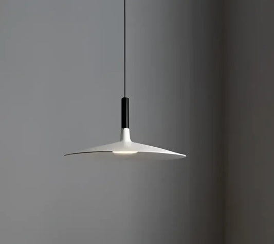 Minimalist white and black glass pendant light with a sleek disc-shaped shade for bedroom use