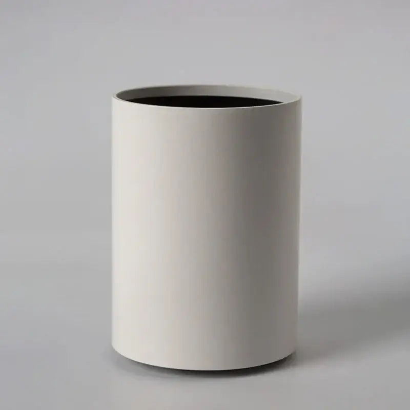Minimalist white cylindrical wastebasket with matte finish and black interior complements decorbites led ceiling light