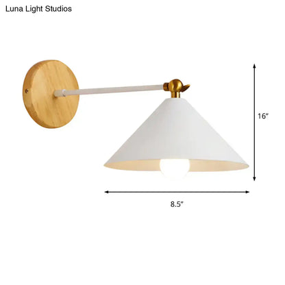 Minimalist white and brass pyramid wall lighting with conical shade and natural wood circular backplate for bedroom use