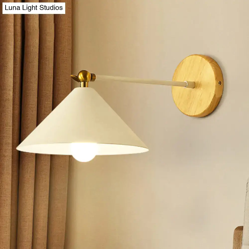 Minimalist white and brass pyramid wall lighting with a conical shade and wooden base for bedroom sconce use