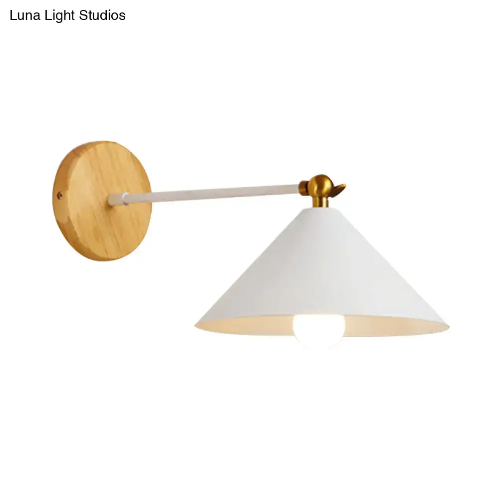 Minimalist pyramid wall lighting with natural wood backplate, white matte conical shade, and brass articulated arm