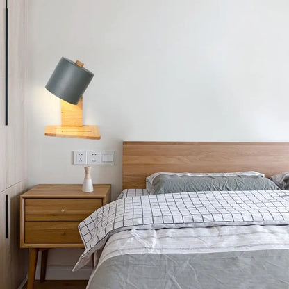 Modern gray cylindrical wall lamp with wooden base and adjustable head in minimalist white green nordic bedroom light