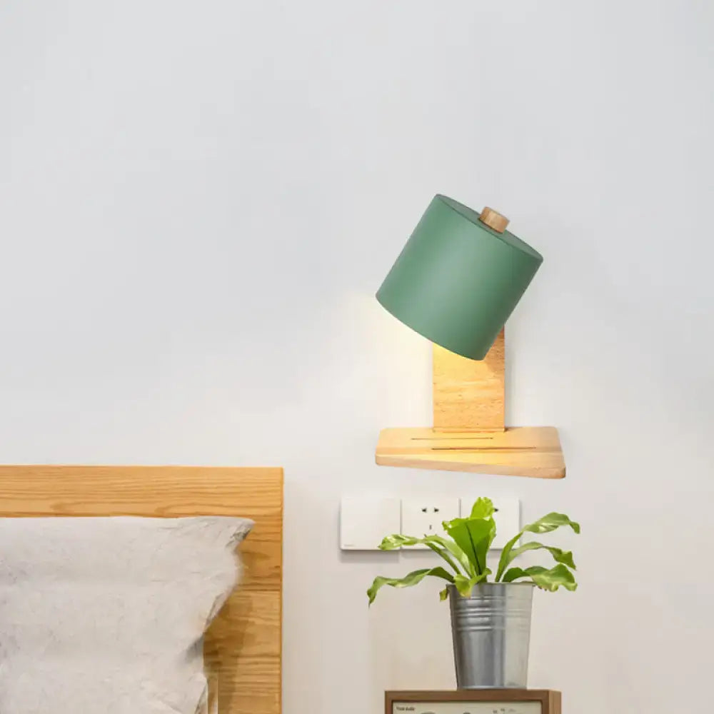 Green cylindrical wall lamp with wooden base and adjustable head in minimalist white green nordic wood bedroom sconce