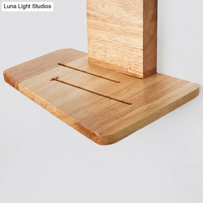 Light brown wooden wall-mounted shelf with vertical support and two slots for minimalist white green nordic decor