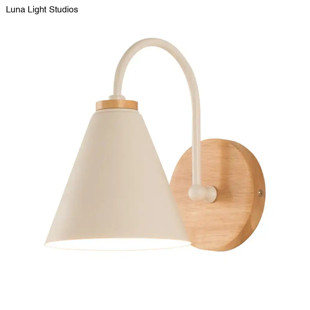 Minimalist wall sconce with cream conical lampshade, curved white metal arm, and natural wood base wall light for bedroom