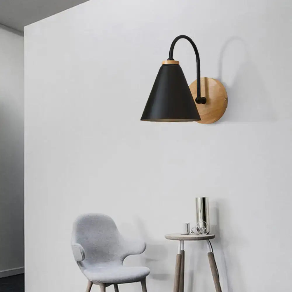 Minimalist black conical wall sconce with curved metal arm and natural wood backplate for bedroom wall light use