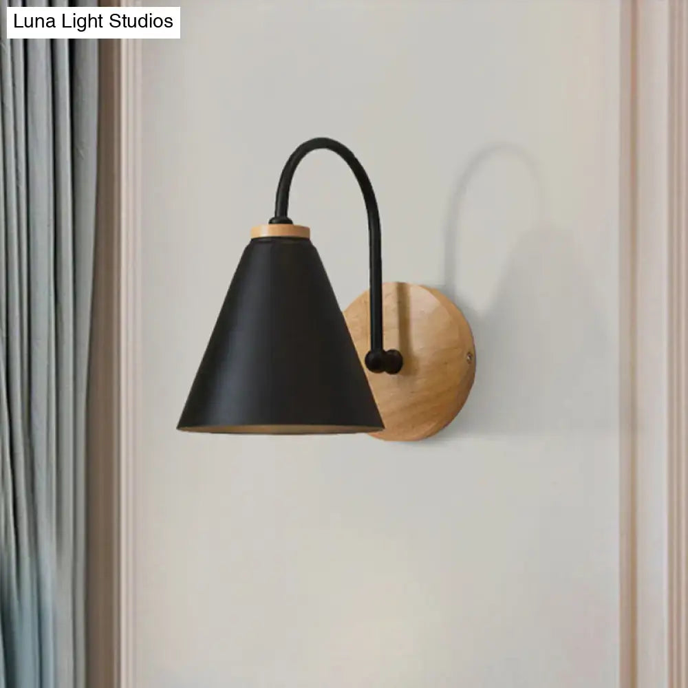 Black conical metal wall sconce with curved arm and wooden plate ideal for minimalist bedroom wall light use