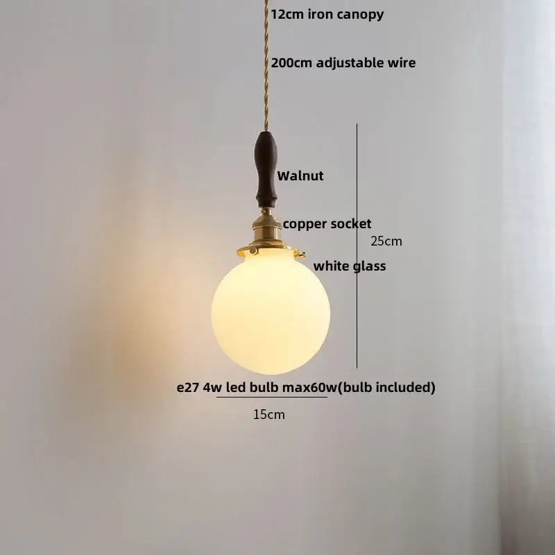 A warm white glass led pendant lamp with brass copper socket and walnut handle for minimalist dining room lighting